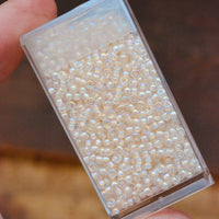 11/0 Pale Peach Lined Crystal AB
