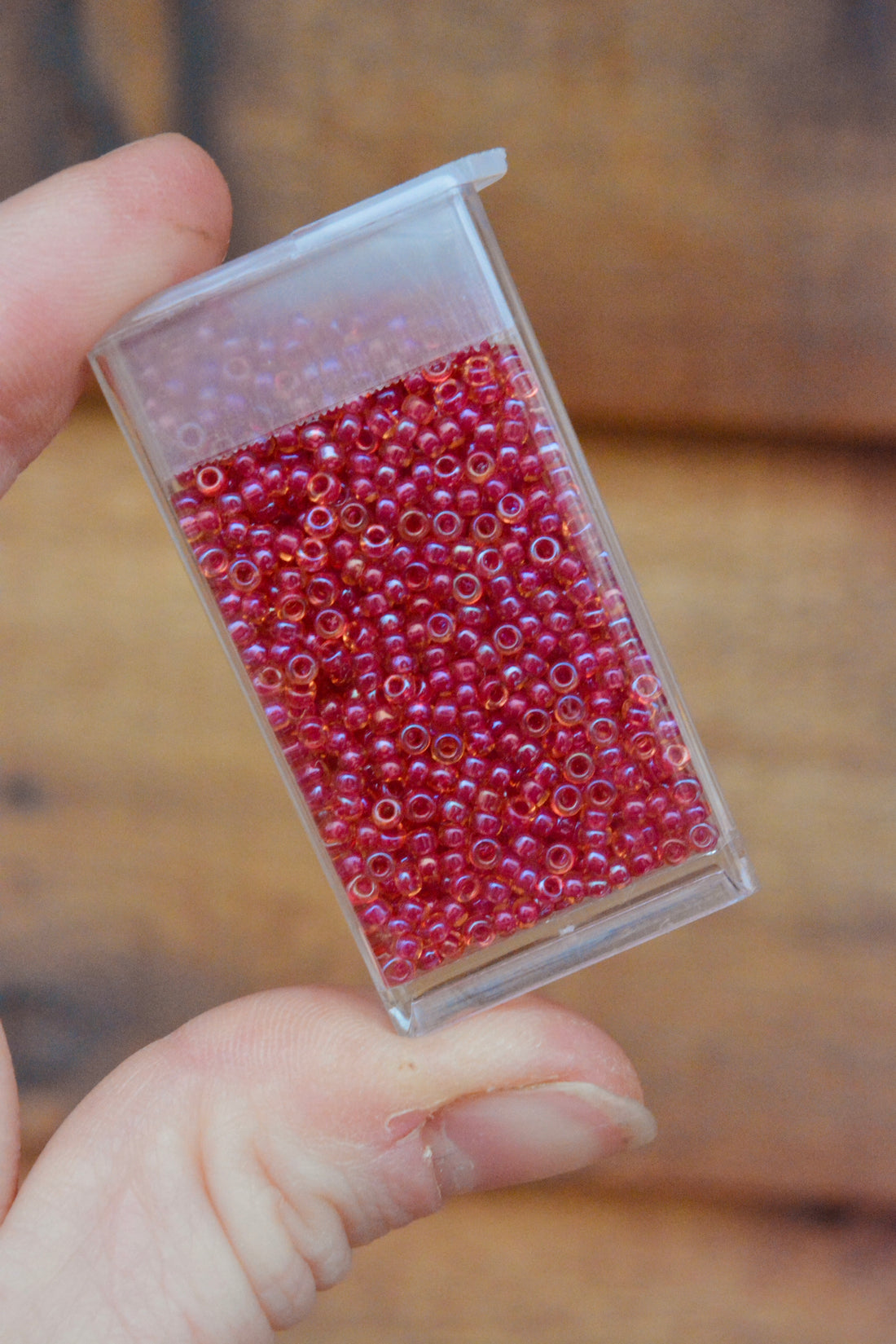 11/0 Light Cranberry Lined Topaz Luster