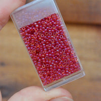 11/0 Light Cranberry Lined Topaz Luster