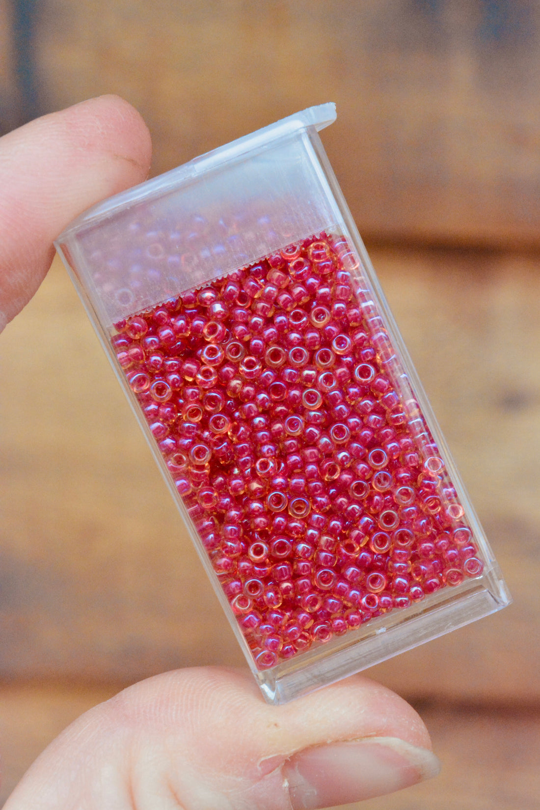 11/0 Light Cranberry Lined Topaz Luster